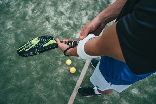 person-holding-black-and-green-tennis-racket-1103829